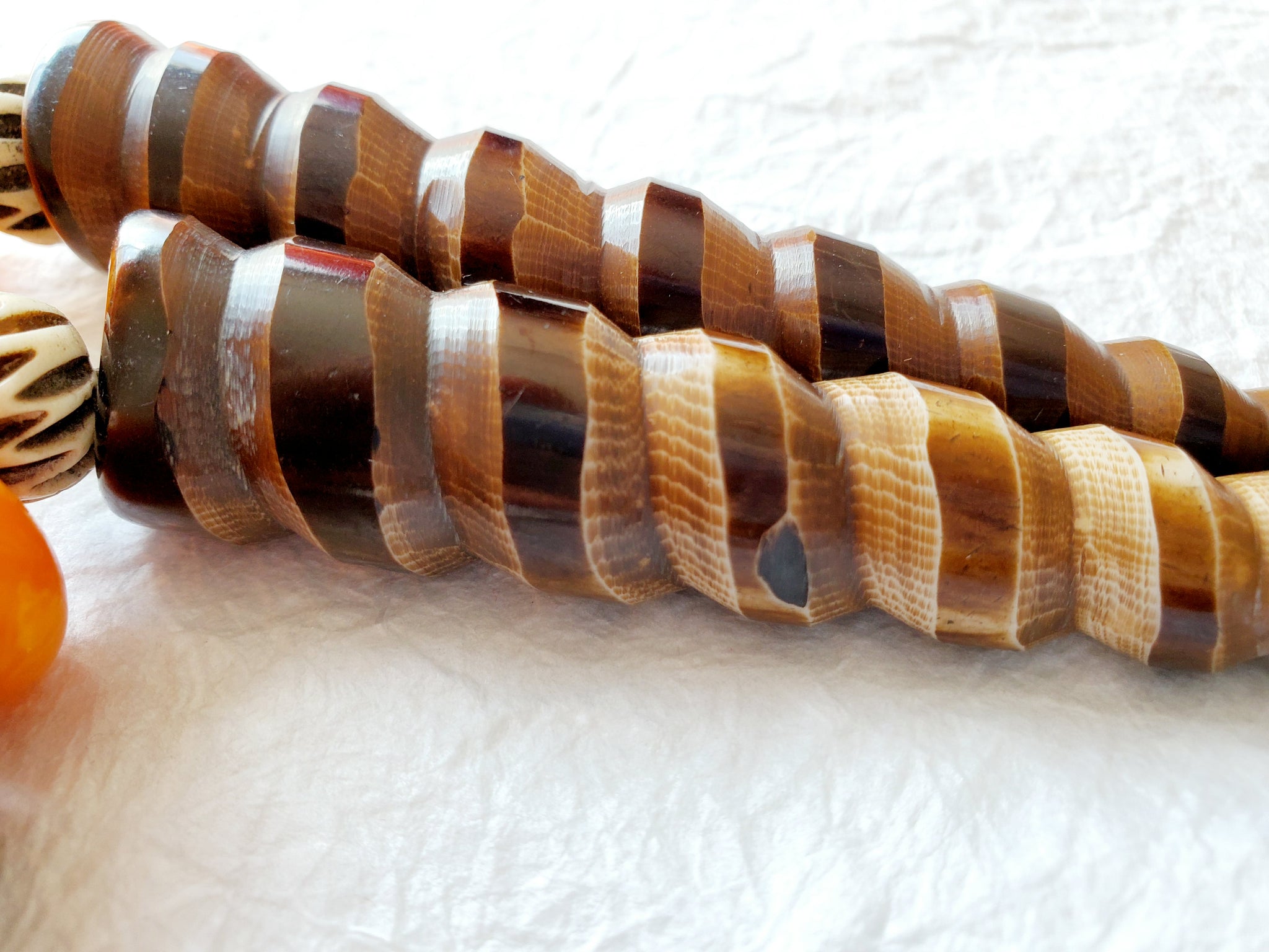 Carved Spiral Horn Bone Cone-shaped Orange Copal Amber Resin Polka Dot Batik Bone Bead Necklace, The Clove